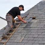 roof repair image showing a man fixing the roof