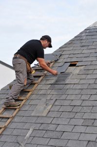 roof repair image showing a man fixing the roof