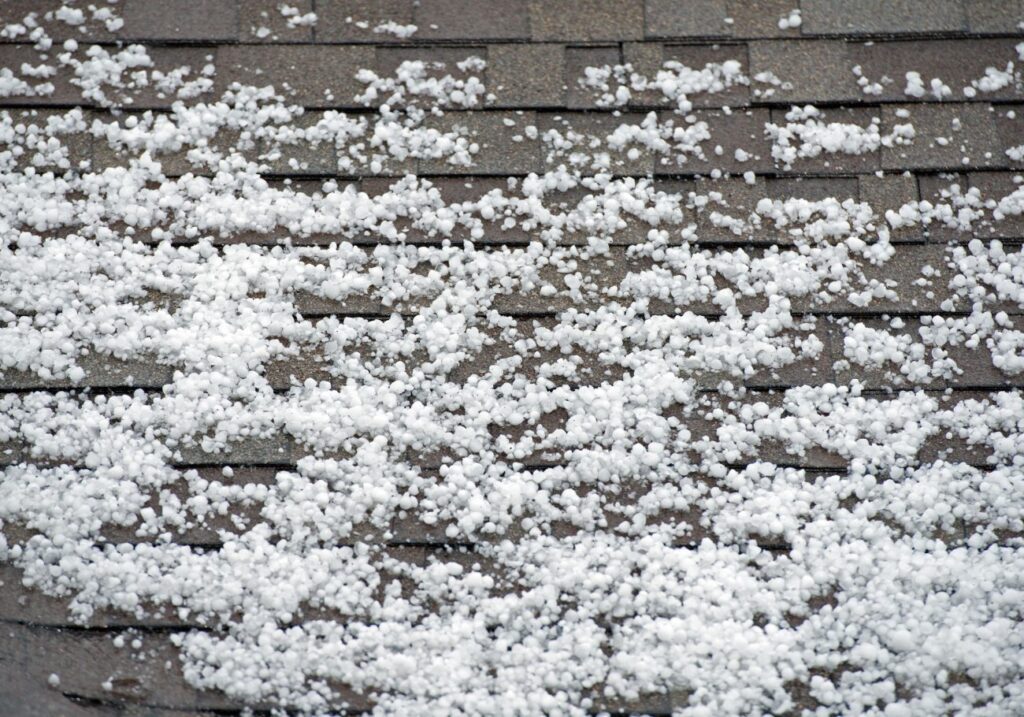 Hail accumulation on a residential roof in colorado, highlighting the need for immediate hail storm roof repair after severe weather.