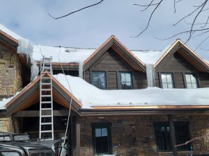 House with ice dam on residential roofing in Colorado winter