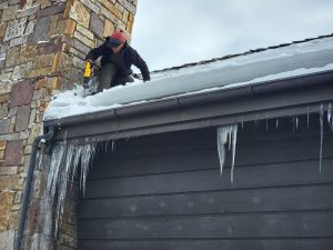 Ice dams formation on roof, posing risks to roofing integrity